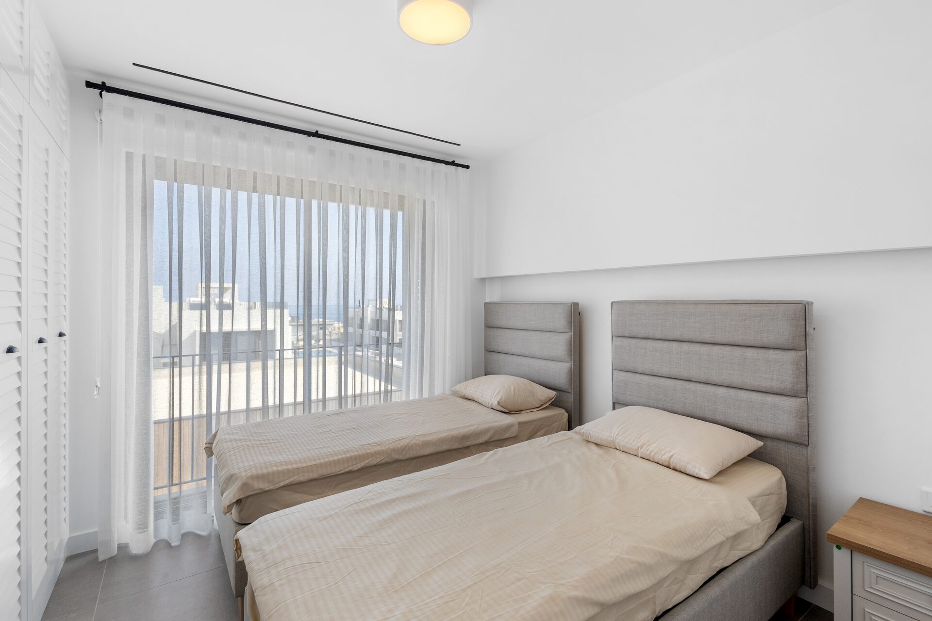 Twin bedroom with sea-facing balcony
